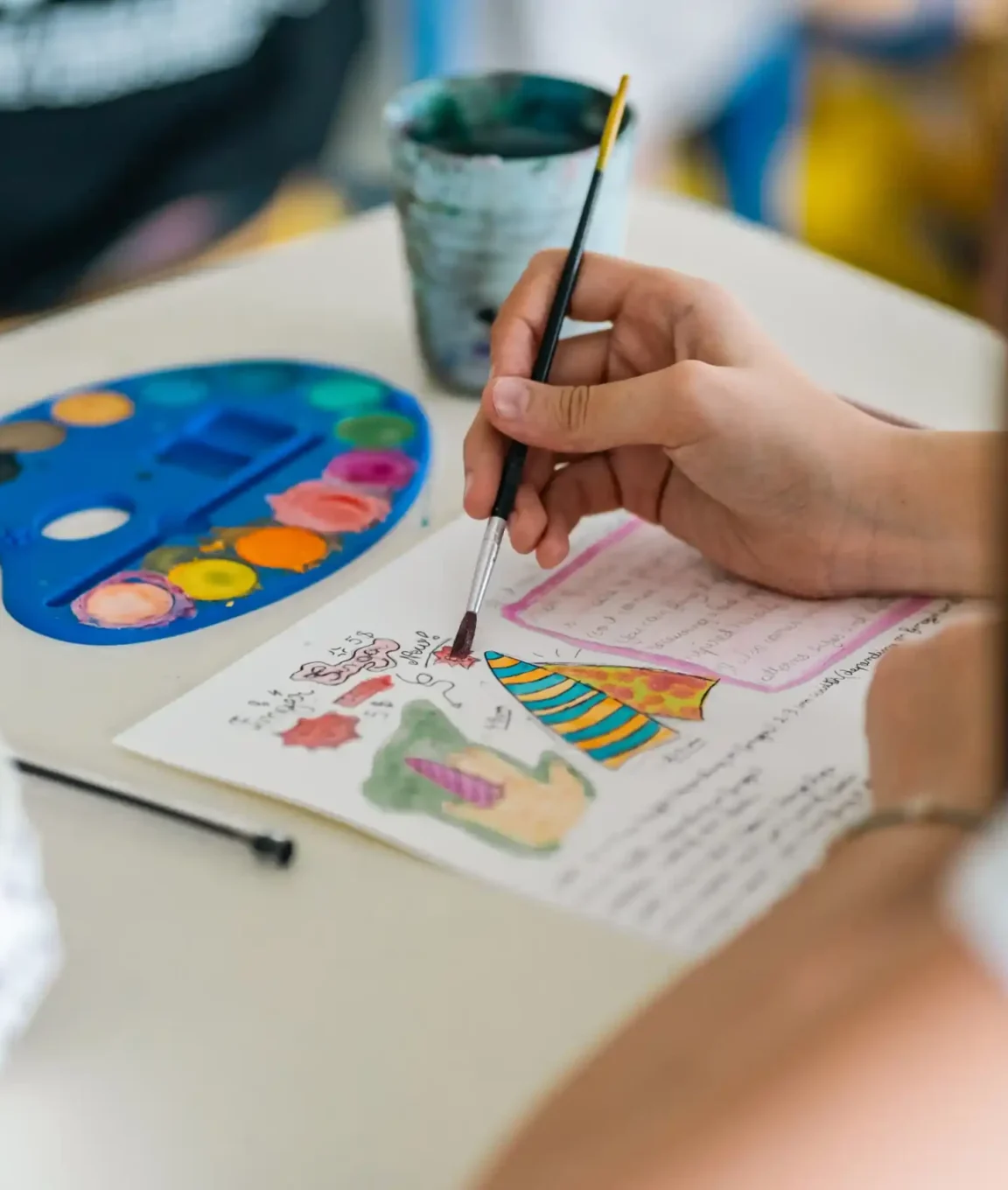 Palette d'aquarelle et pinceau lors d'un atelier d'arts plastiques